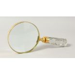 A MAGNIFYING GLASS with cut glass handle.