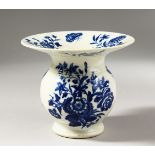 A RARE WORCESTER BLUE AND WHITE SPITTOON, decorated with scattered flowering plants and a butterfly,