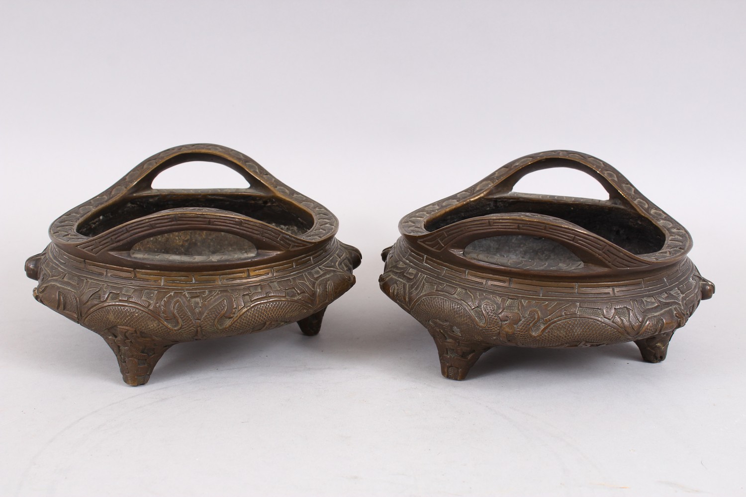 TWO GOOD CHINESE BRONZE TRIPOD CENSERS, Both with deep carved scenes of chilongs and archaic design, - Image 2 of 9