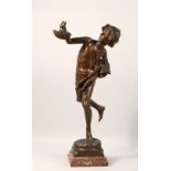 A GOOD BRONZE FIGURE, of a young boy holding a basket in his hand, on a stepped marble base. 24ins