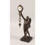 A BRONZE "MYSTERY CLOCK", modelled as an aviator holding a propeller. 15ins high.