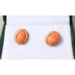 A PAIR OF 9CT GOLD ROUND CORAL EARRINGS.