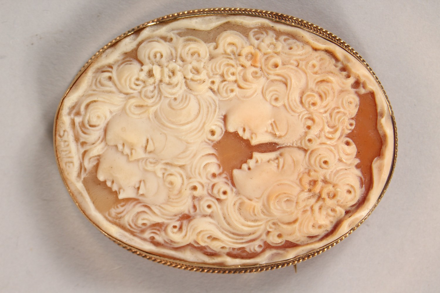 A GOOD VICTORIAN GOLD MOUNTED CAMEO BROOCH, carved with the busts of four young ladies. 2.5ins x - Image 2 of 4