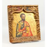 A 19TH CENTURY RUSSIAN ICON, depicting a saint, in a carved border, old Sotheby's label verso. 15ins