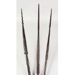 THREE PAPUA NEW GUINEA CARVED BARBED SPEARS, undecorated. Longest: 8ft 9ins (3).