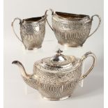 A THREE PIECE TEA SERVICE, comprising teapot, milk jug and sugar bowl, with fluted and embossed
