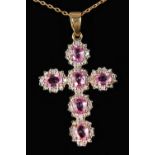 A 9CT GOLD, PINK SAPPHIRE AND DIAMOND CROSS ON A CHAIN.