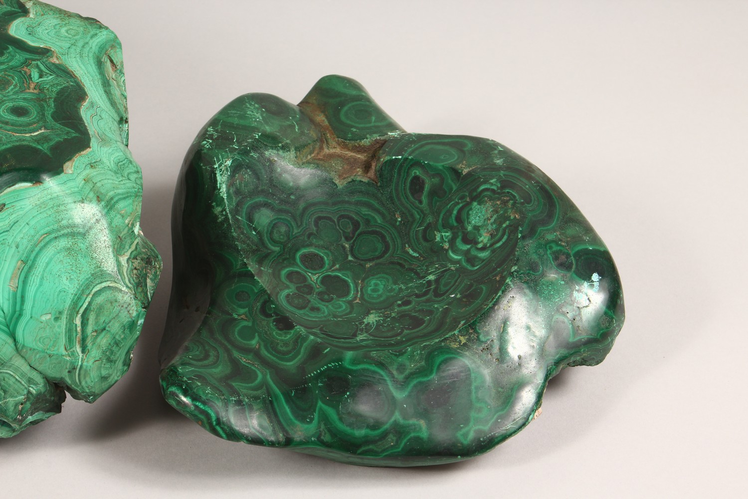 A LARGE NATURALISTIC PIECE OF MALACHITE, partially carved to form a dish, and two similar pieces ( - Image 4 of 9