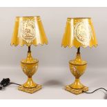 A PAIR OF YELLOW TOLEWARE STYLE URN SHAPED TABLE LAMPS AND SHADES. 21ins high.