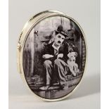 A SILVER OVAL PILL BOX, the lid with an enamel of Charlie Chaplin.