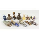 A GROUP OF THIRTEEN ROMAN GLASS BOTTLES AND JARS, including three tops in the form of heads (13).