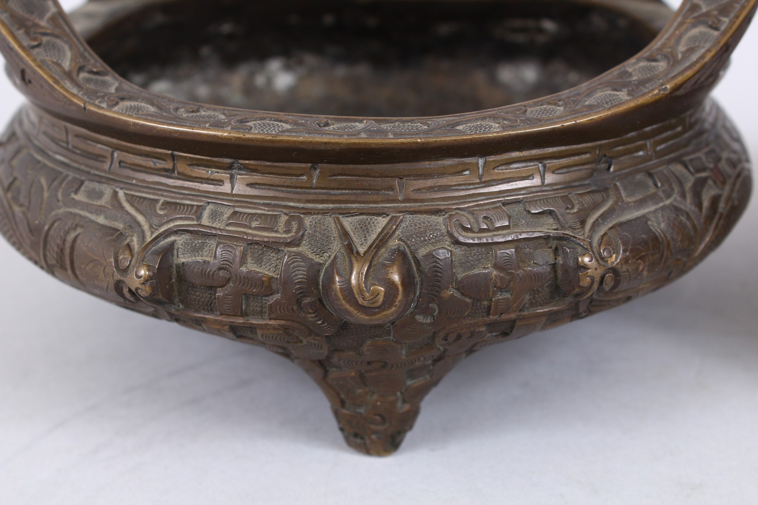 TWO GOOD CHINESE BRONZE TRIPOD CENSERS, Both with deep carved scenes of chilongs and archaic design, - Image 5 of 9