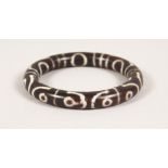 A TIBETAN STYLE HARDSTONE BANGLE. 3ins diameter.