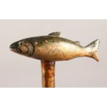 A WALKING STICK with carved and painted salmon handle. 50ins long.