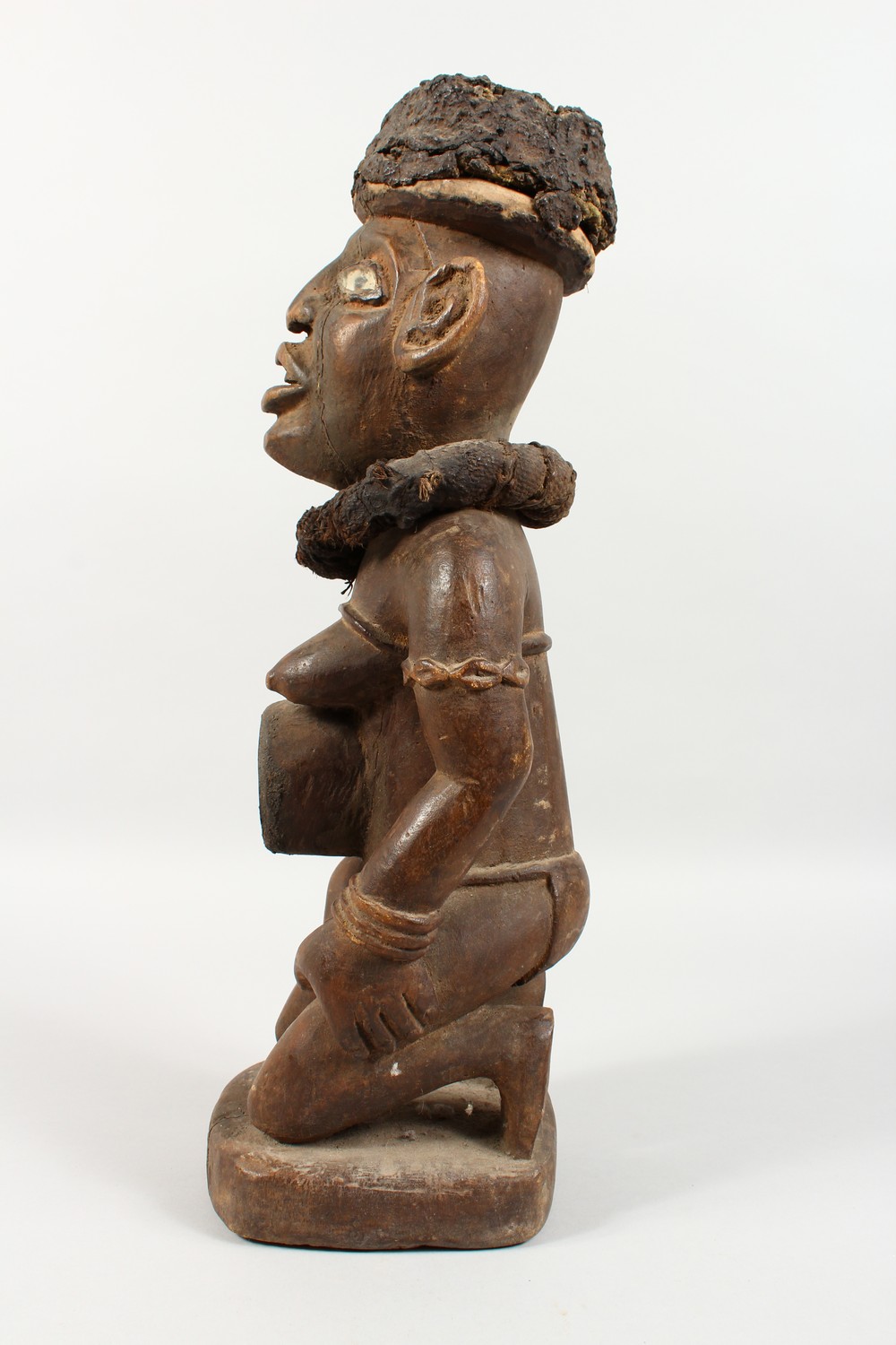 A CARVED WOOD AFRICAN FIGURE, a kneeling female nude wearing a large collar. 20ins high. - Image 3 of 8