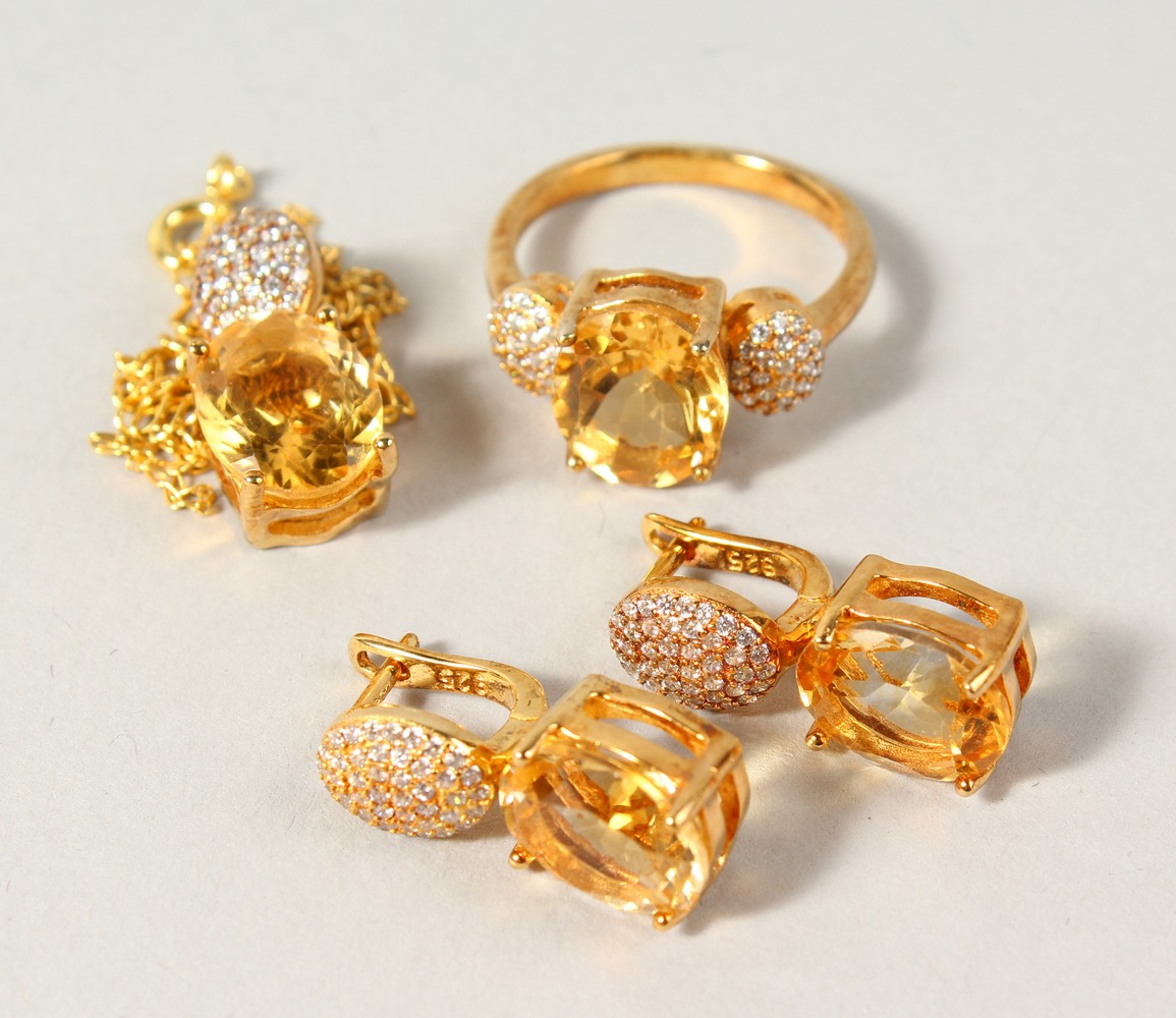 A SILVER AND GOLD PLATED CITRINE PENDANT, EARRINGS AND RING.