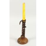 AN EARLY IRON CANDLESTICK, on turned wood base. 7.5ins high.