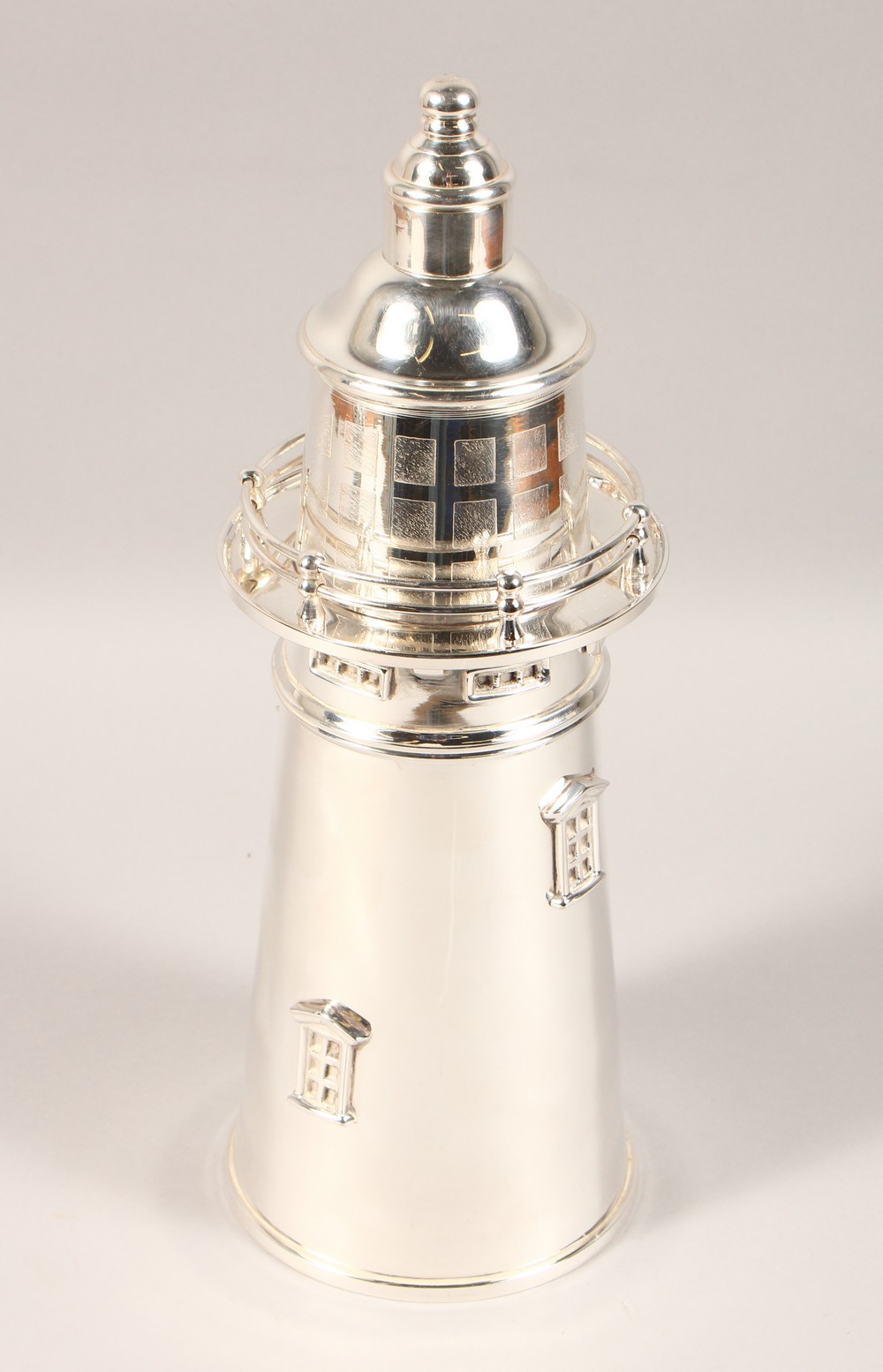 A NOVELTY LIGHTHOUSE SHAPE COCKTAIL SHAKER. 14ins high.