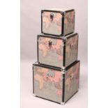 A SET OF THREE SQUARE TRUNKS, printed with maps of the world. Largest: 1ft 6ins wide.