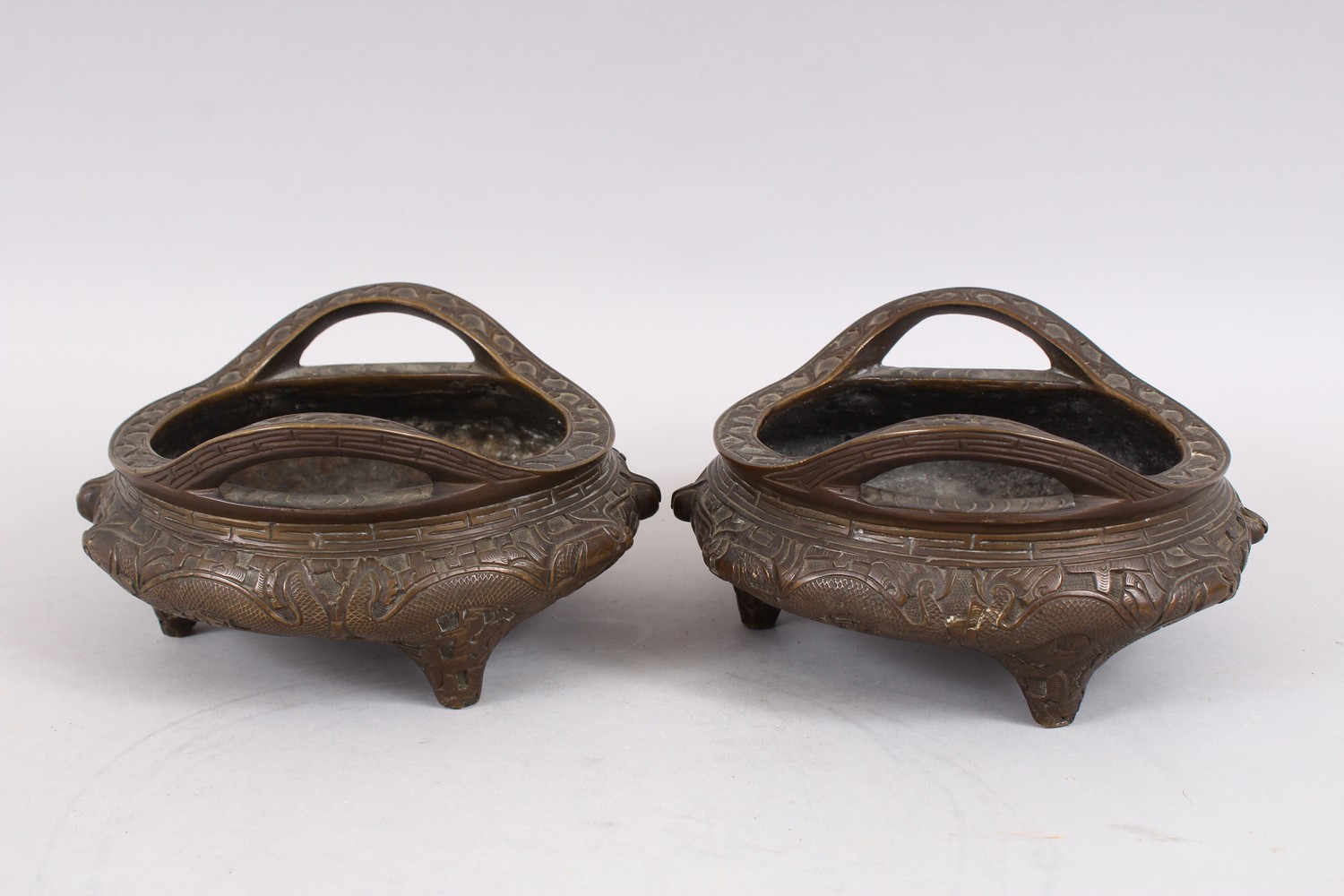 TWO GOOD CHINESE BRONZE TRIPOD CENSERS, Both with deep carved scenes of chilongs and archaic design, - Image 4 of 9