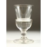 A GOOD TRUMPET SHAPED PLAIN GLASS on a large circular base. 7ins high.