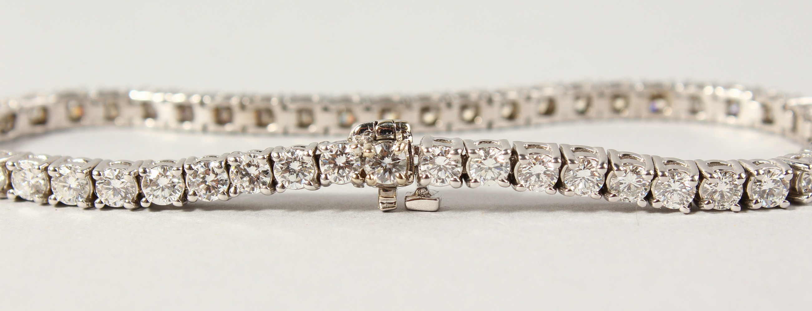 AN 18CT WHITE GOLD DIAMOND LINE BRACELET, with forty-nine diamonds, approx. 6CTS, G/H Colour, V1- - Image 11 of 19