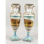 A PAIR OF SEVRES STYLE CLASSICAL TWIN-HANDLED PEDESTAL VASES, decorated with street scenes. 19ins