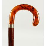 A WALKING STICK with faux-tortoiseshell handle and silver band. Birmingham. 2ft 1in long.