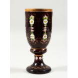 A BOHEMIAN RUBY COLOURED GLASS GOBLET, with painted floral decoration. 7ins high.