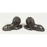 A PAIR OF 19TH CENTURY SMALL CAST IRON MODELS OF LIONS. 6ins long.