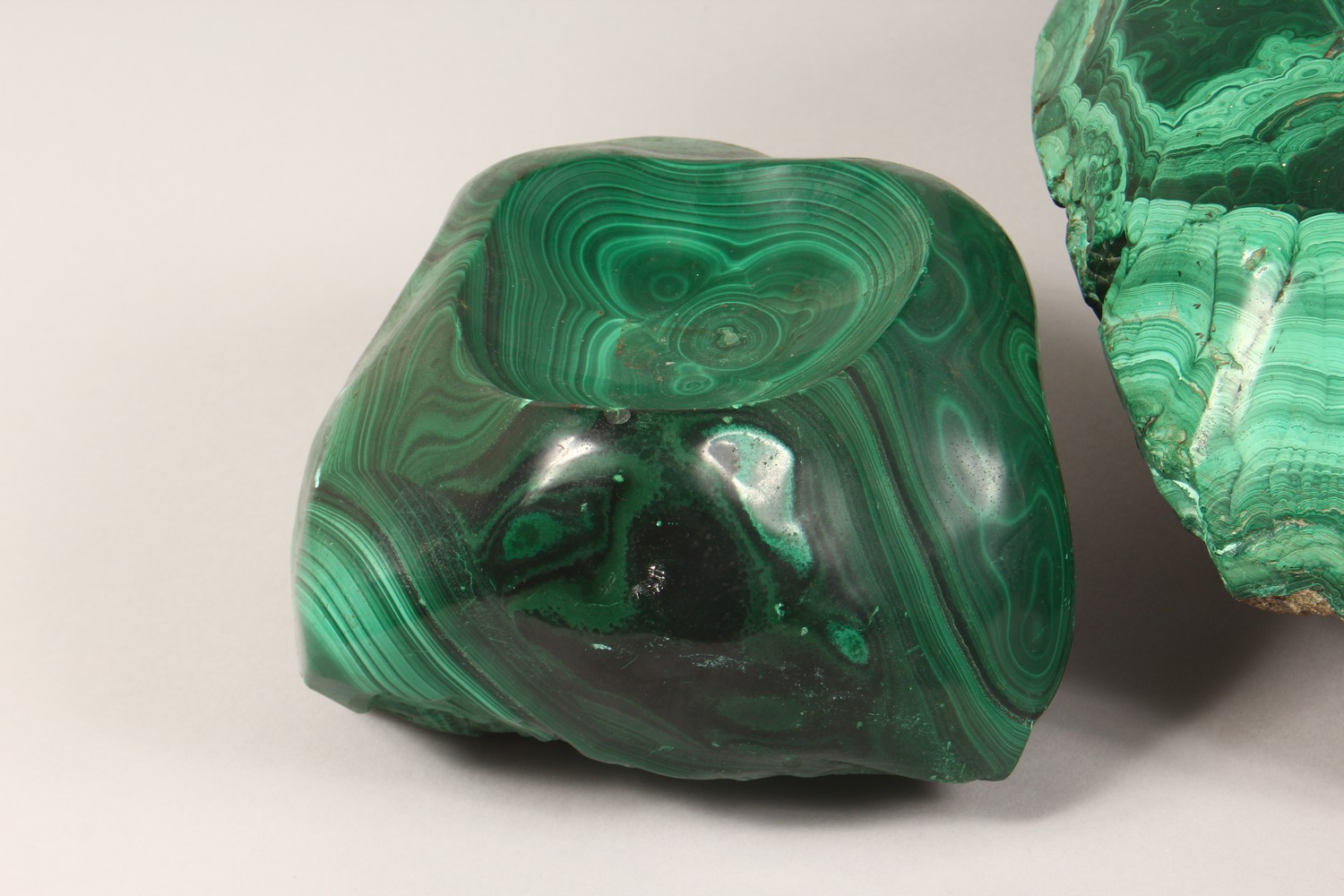 A LARGE NATURALISTIC PIECE OF MALACHITE, partially carved to form a dish, and two similar pieces ( - Image 2 of 9