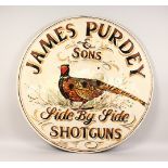 A DECORATIVE CIRCULAR PAINTED PLYWOOD SIGN: "JAMES PURDEY & SONS". 35.5ins diameter.