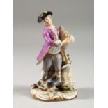A SMALL MEISSEN FIGURE OF A MAN PLAYING BAGPIPES, a dog and sheep at his feet, cross swords mark
