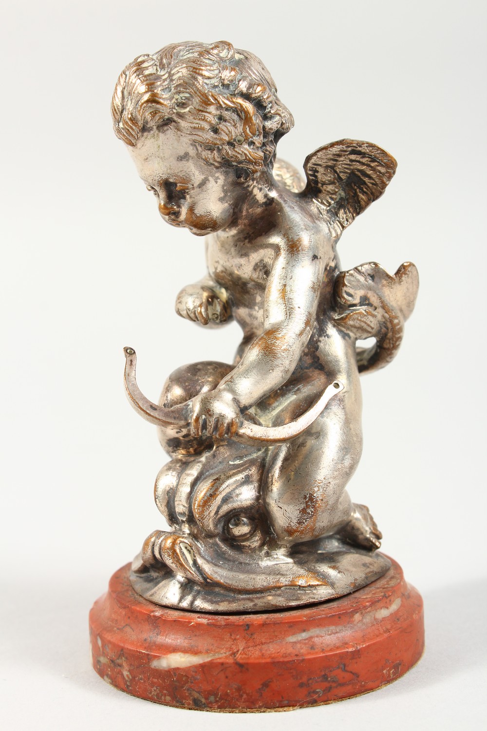 A SILVERED CAST METAL MODEL OF CUPID RIDING ON A DOLPHIN, on a marble base. 5ins high overall. - Image 2 of 3