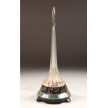 AN UNUSUAL RUSSIAN COMMEMORATIVE TABLE LAMP, of spire shape with rocket finial, dated 1976-1980.