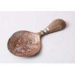 AN EARLY AND RARE ISLAMIC ENGRAVED BRASS CADDY SPOON, 12cm long.