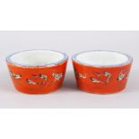 A GOOD PAIR OF CHINESE DAOGUANG CORAL GROUND PORCELAIN BRUSH WASHERS, the pots decorated with scenes