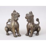 A PAIR OF 20TH CENTURY CHINESE BRONZE QUILIN / GUARDIAN DOGS, both in seated poses, 12cm high x 11cm