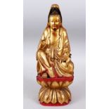 A GOOD QUALITY 18TH / 19TH CHINESE GILTWOOD CARVED FIGURE OF GUANYIN, in a seated position with a