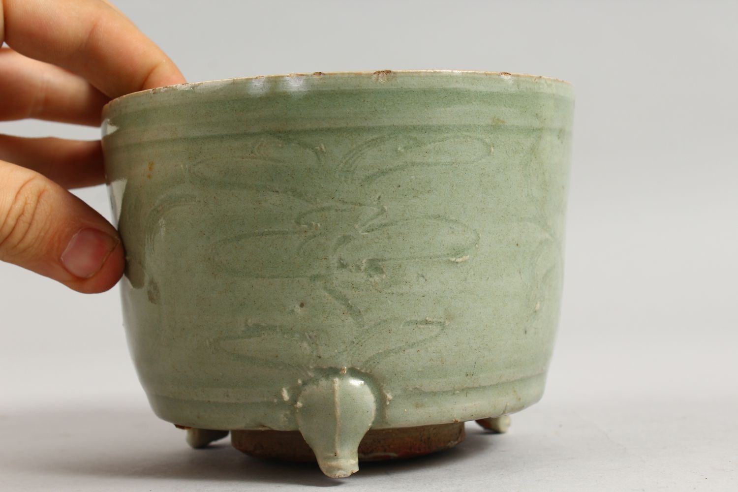 AN EARLY CHINESE LONGQUAN CELADON CIRCULAR CELADON CENSER on three legs. 5.5ins diameter. - Image 3 of 7