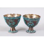 A PAIR OF 19TH CENTURY PERSIAN QUAJAR TURQUOISE SINSET SILVER CUPS, the cups with scalloped rims and