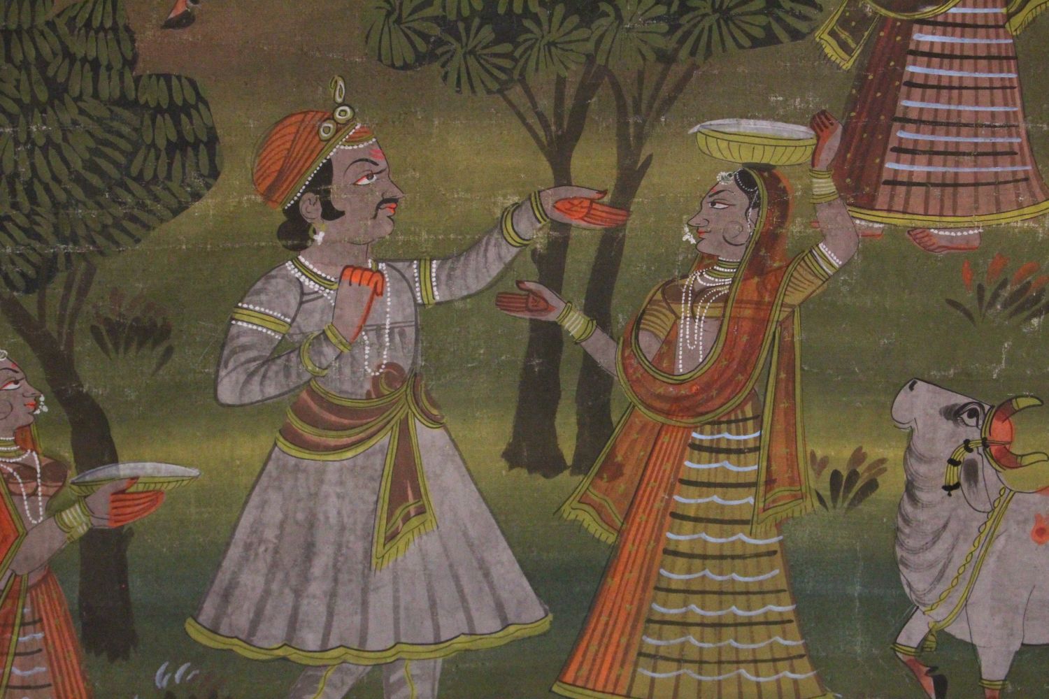 A 19TH-20TH CENTURY FRAMED INDIAN PAINTING ON TEXTILE depicting a prince presenting orange paint - Image 2 of 3