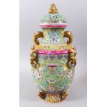 A 19TH / 20TH CENTURY CHINESE FAMILLE ROSE TWIN HANDLE PORCELAIN VASE, decorated on a green ground