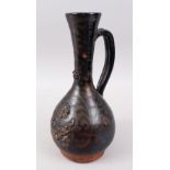 A 19TH CENTURY OTTOMAN TURKISH CANAKKALE BROWN GLAZED JUG, 33cm high.