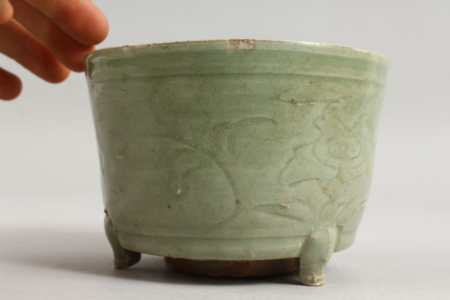 AN EARLY CHINESE LONGQUAN CELADON CIRCULAR CELADON CENSER on three legs. 5.5ins diameter. - Image 4 of 7