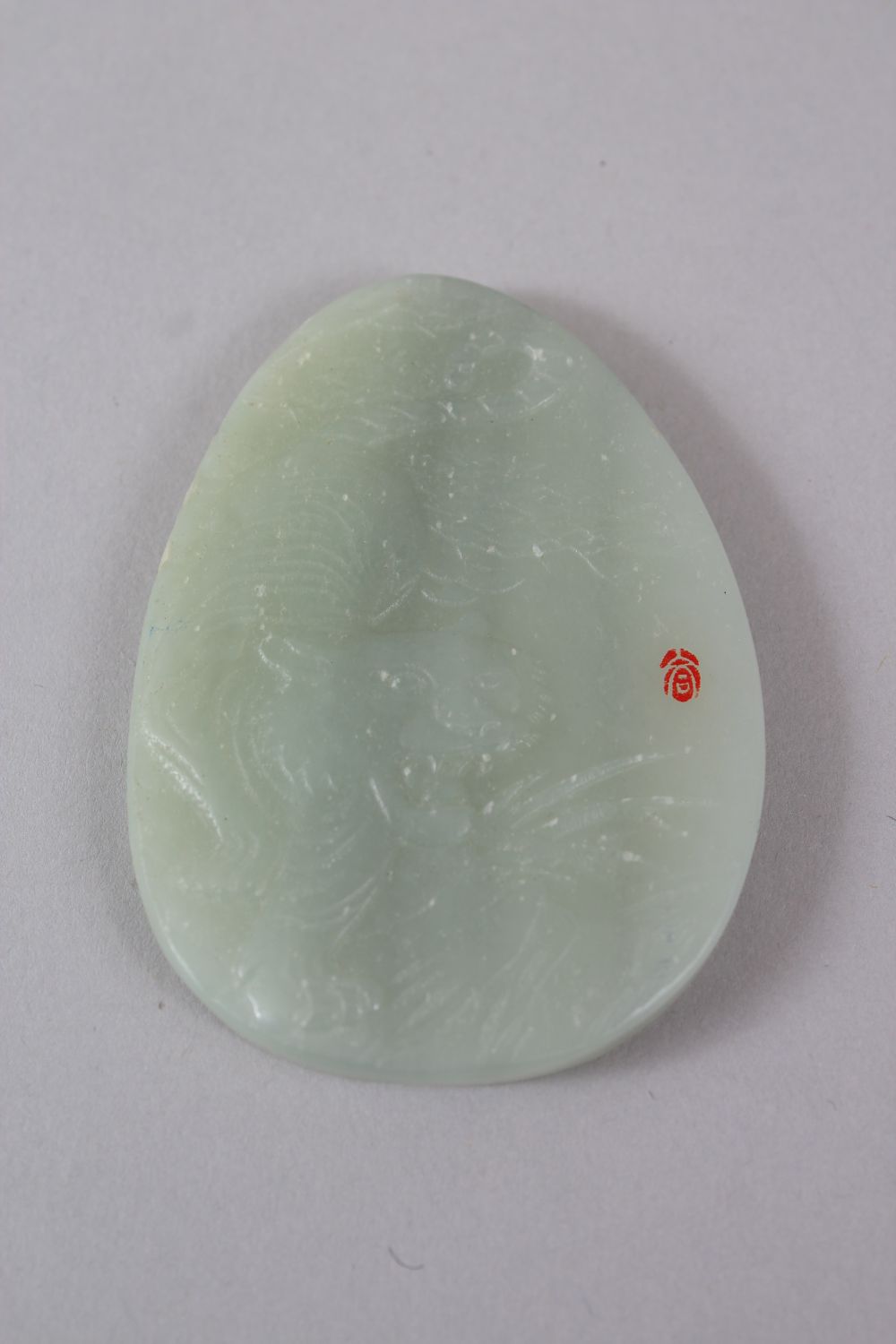 A GOOD 19TH / 20TH CENTURY CHINESE CARVED JADE TIGER PENDANT, with a red seal mark, 6.5cm high x 4. - Image 2 of 2