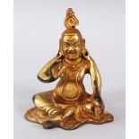 A 19TH CENTURY SINO TIBETAN GILDED BRONZE FIGURE OF A GOD / DEITY, in a seated position baring his