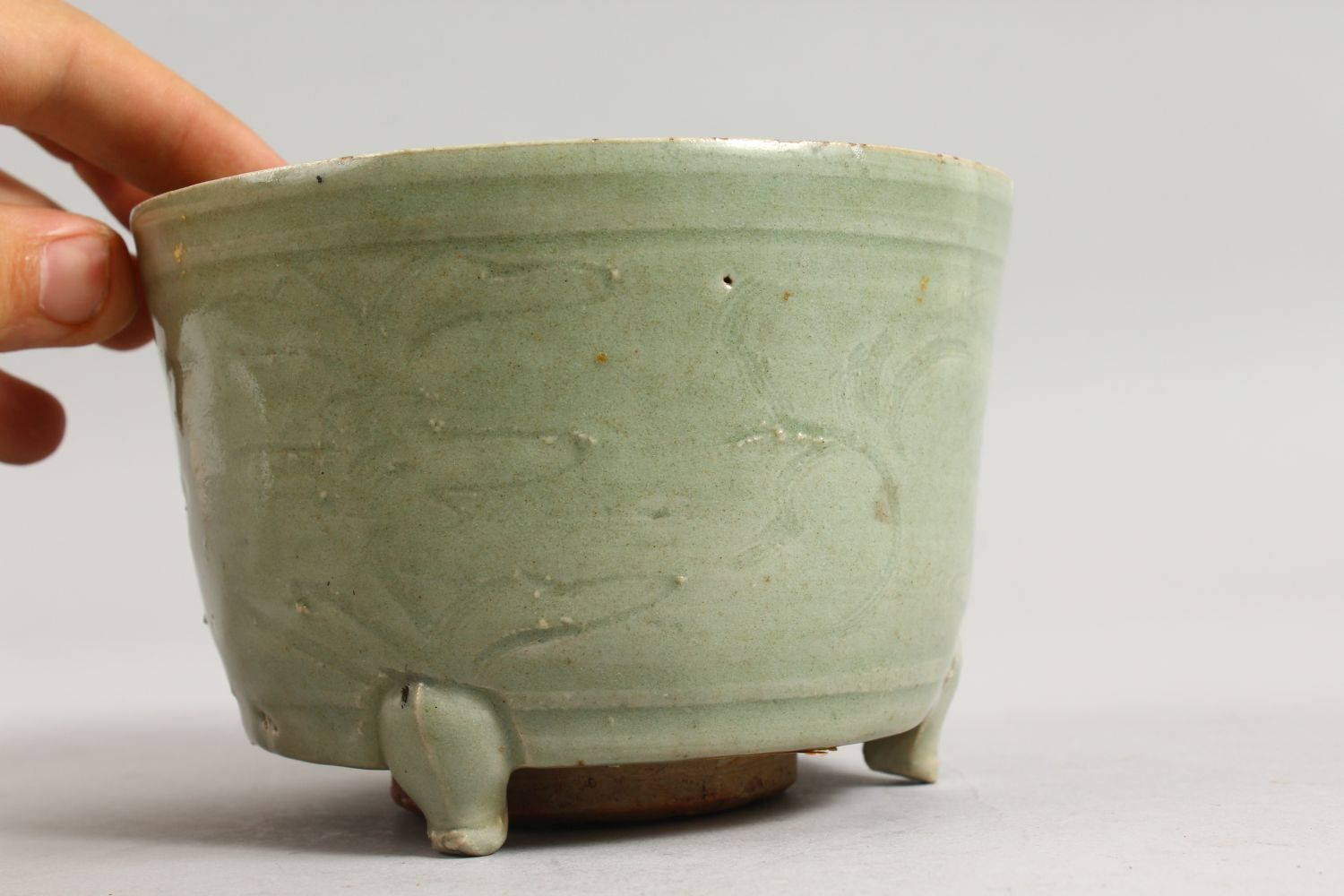 AN EARLY CHINESE LONGQUAN CELADON CIRCULAR CELADON CENSER on three legs. 5.5ins diameter. - Image 2 of 7