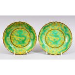 A GOOD PAIR OF CHINESE FAMILLE VERT PORCELAIN DRAGON DISHES, decorated on yellow ground with green