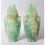 A GOOD PAIR OF CHINESE CARVED ROCK CRYSTAL LIDDED URNS, carved in archaic style with scrolling